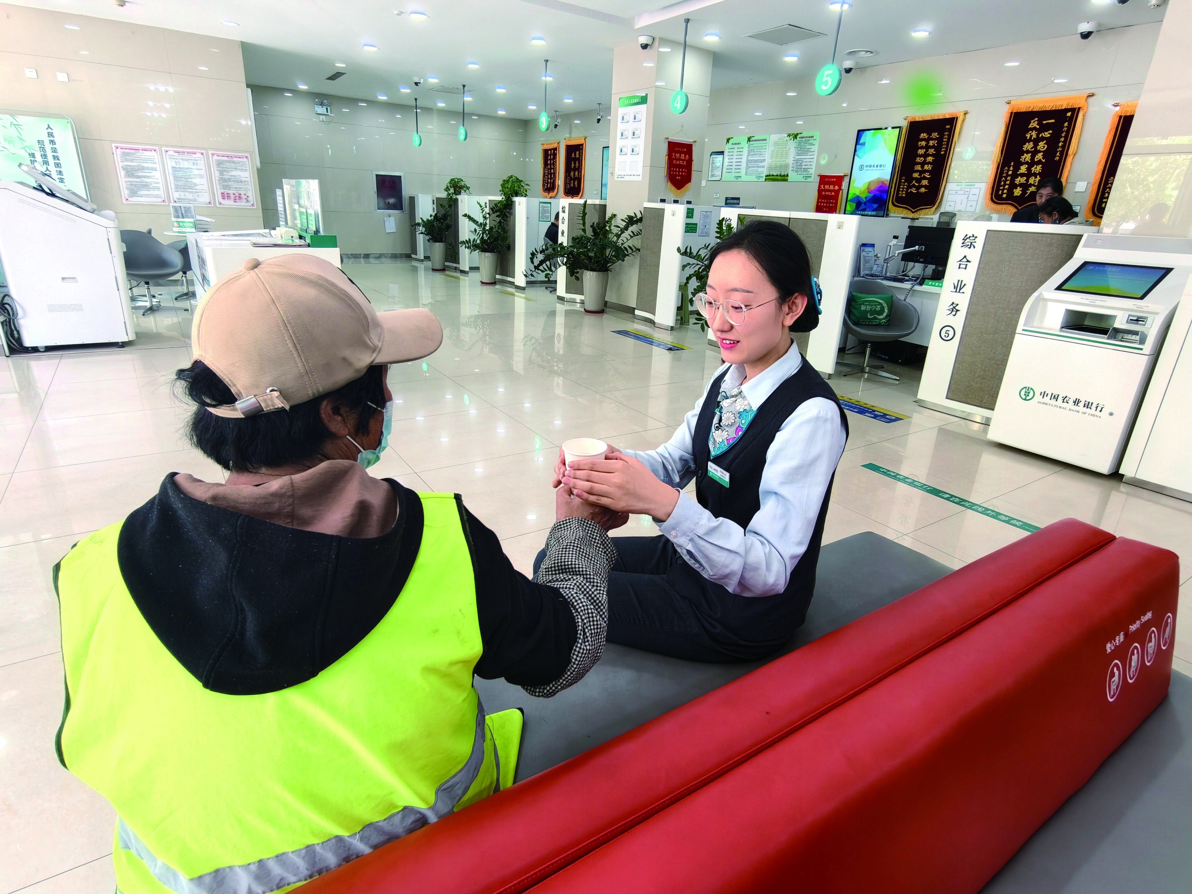 农业银行河北唐山古冶支行深化网点服务内涵，帮助解决户外劳动者实际困难。图为该行邀请户外劳动者来网点休息。柴文佳摄影报道
